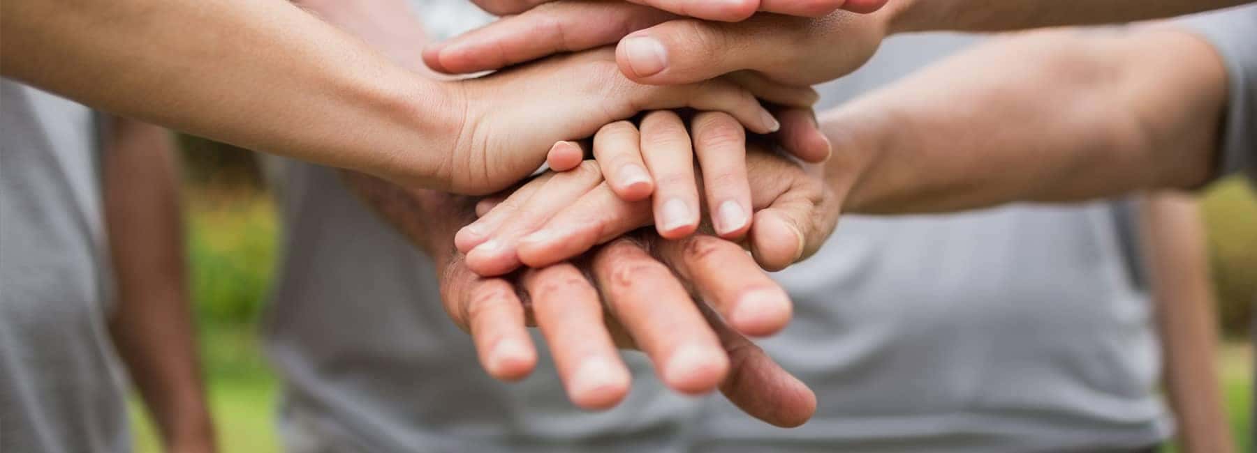 Close Up of Hands on Top of Other Hands
