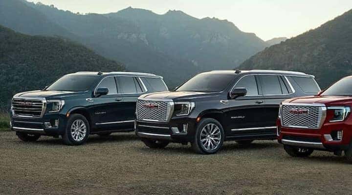 row of 2023 GMC yukons with mountains