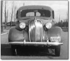 Old black and white photograph of a car from the front