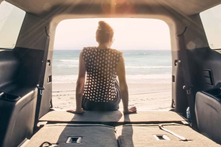 woman-sitting-GMC-SUV-trunk-door-open
