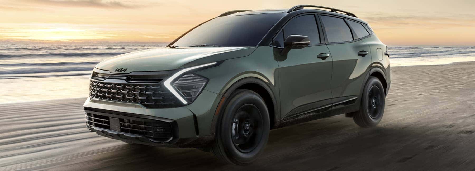 2025 Kia Sportage driving on a beach