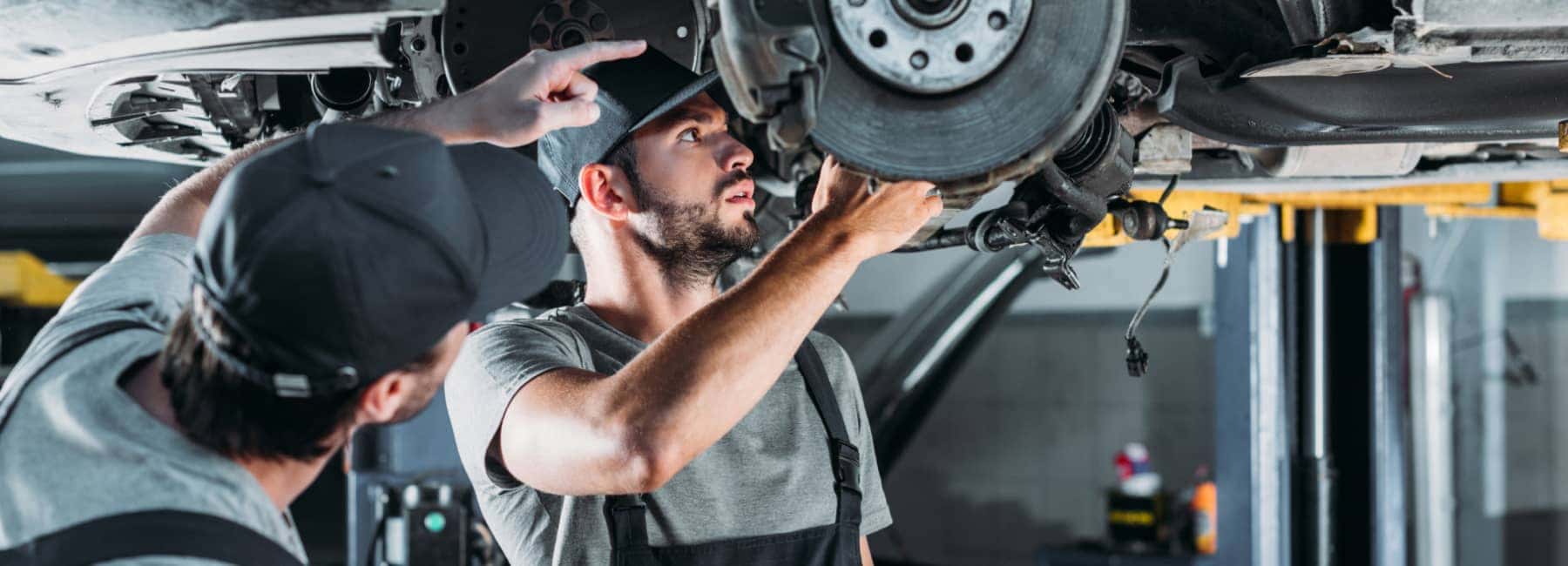 Service technicians working on a vehicle