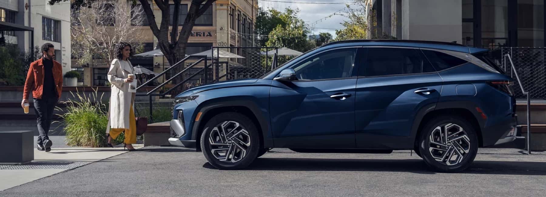 2026-parked-hyundai-tucson-couple-walks-toward-mobile