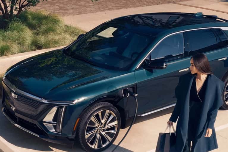 woman-walks-from-charging-LYRIQ-mobile