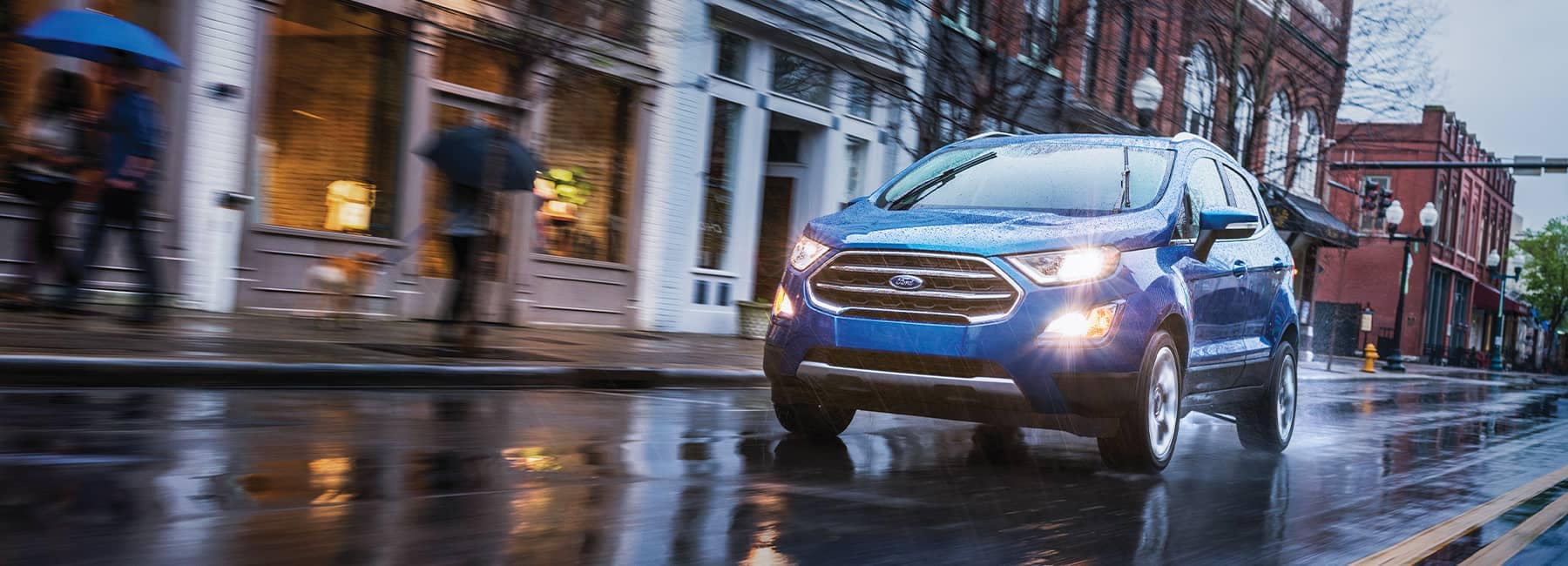 2021 Ford EcoSport driving on a rainy suburban town street