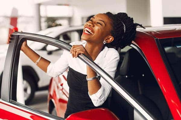 a Person Happy and Holding on a Car Door