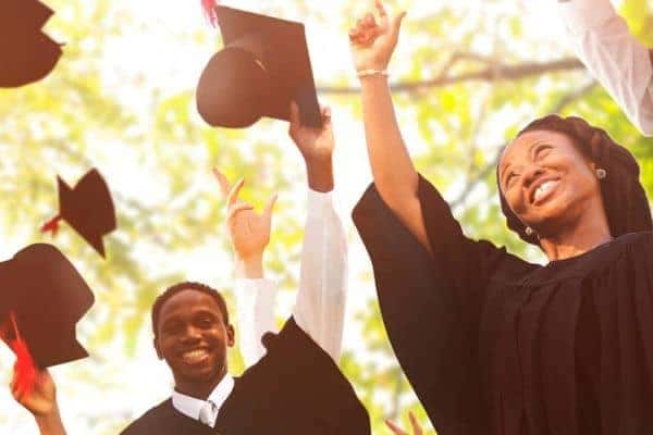 College graduates throwing hats
