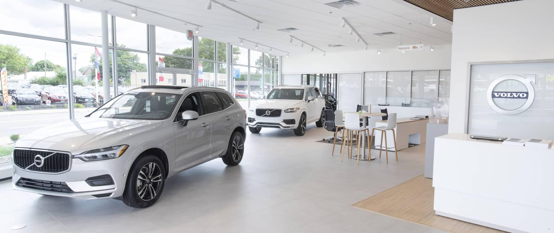 An electric Volvo SUV being charged in a large open room
