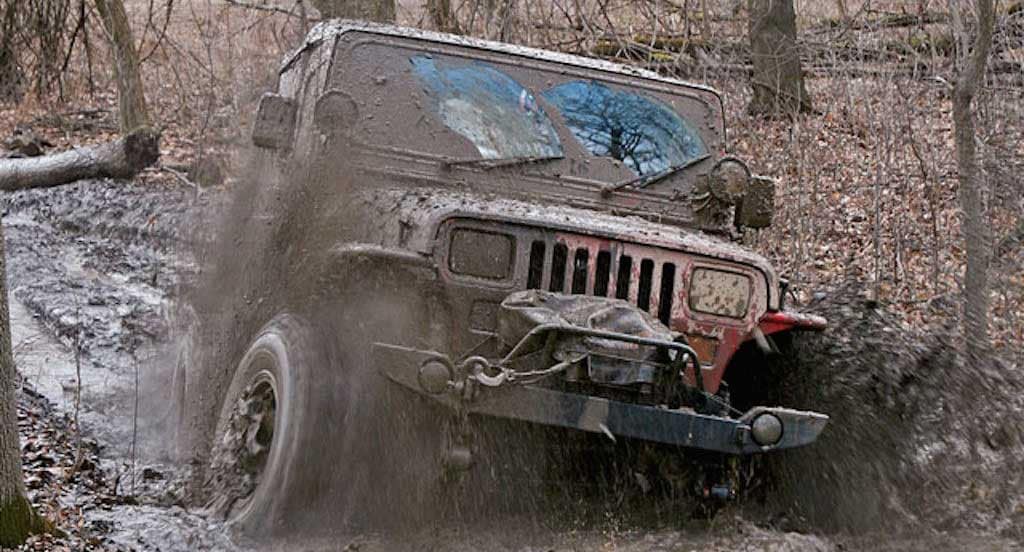 Jeep off roading in mud