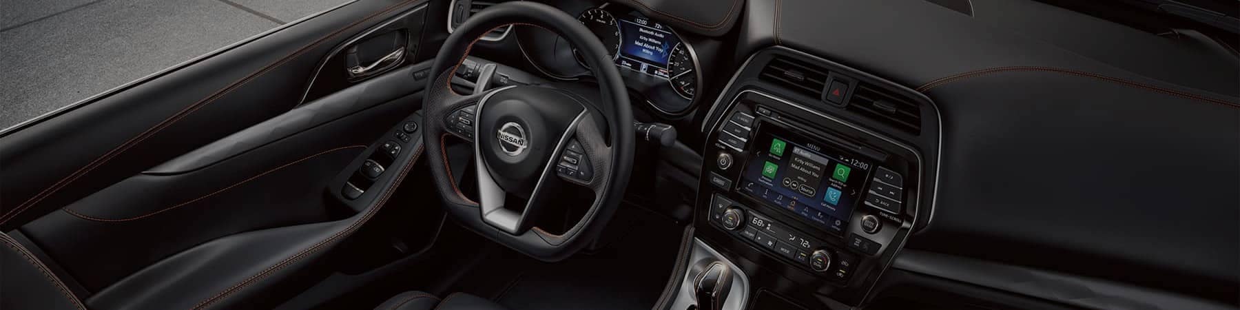 The black leather drivers seat and dashboard of a 2021 Nissan Maxima