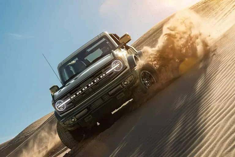 Bronco plowing down sand dune
