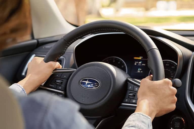 2022 Subaru Ascent interior woman driving showing the steering wheel and digital console