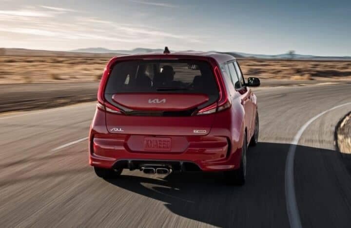 Rearview_of_a_red_2022_Kia_Soul_cruising_on_a_road_o