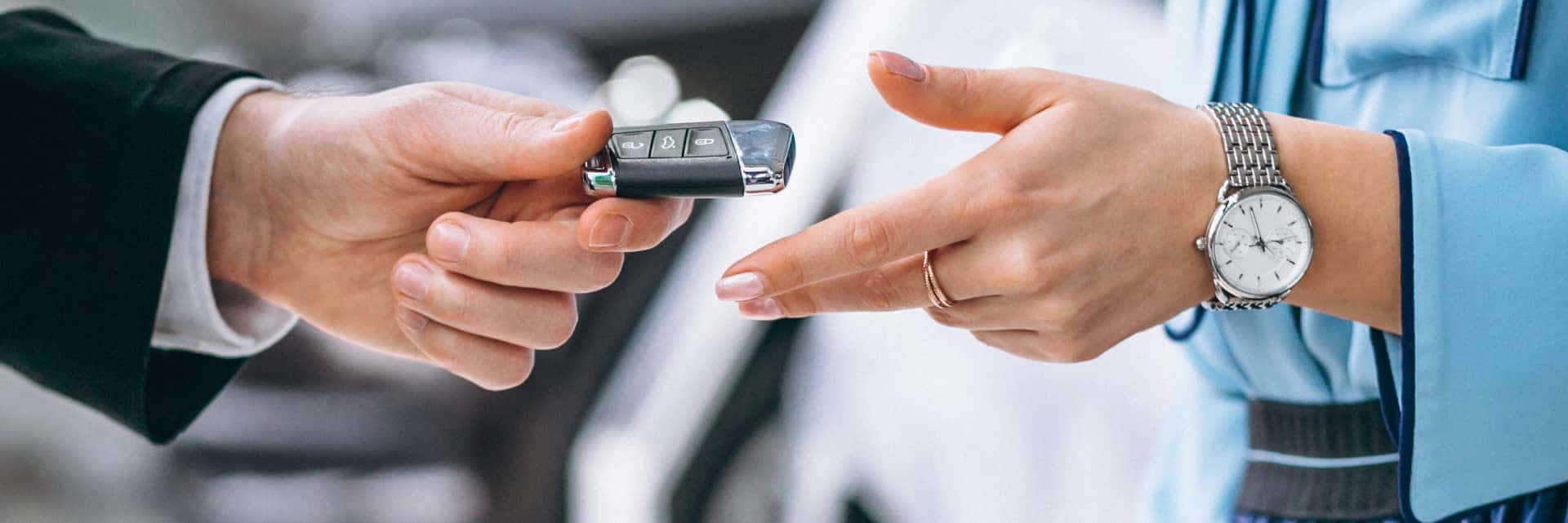 Close up of someone handing car keys over to another person