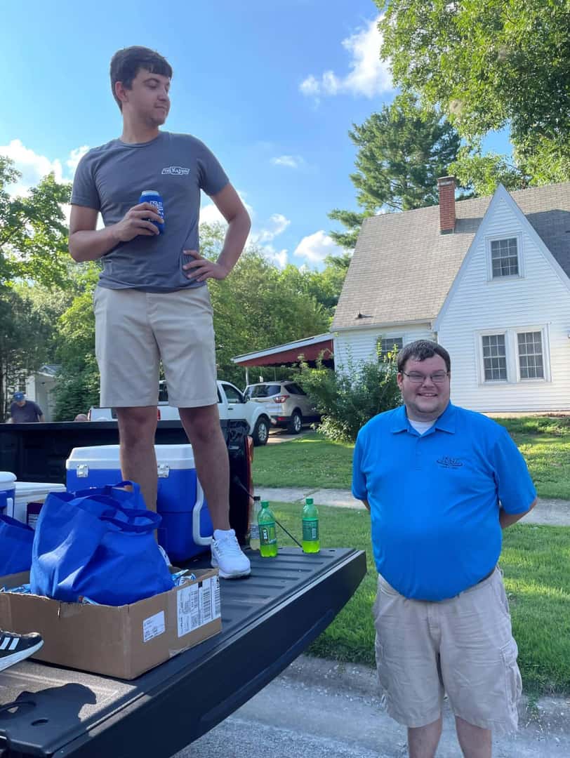 Person-on-truck-gate-while-a-person-is-standing-below