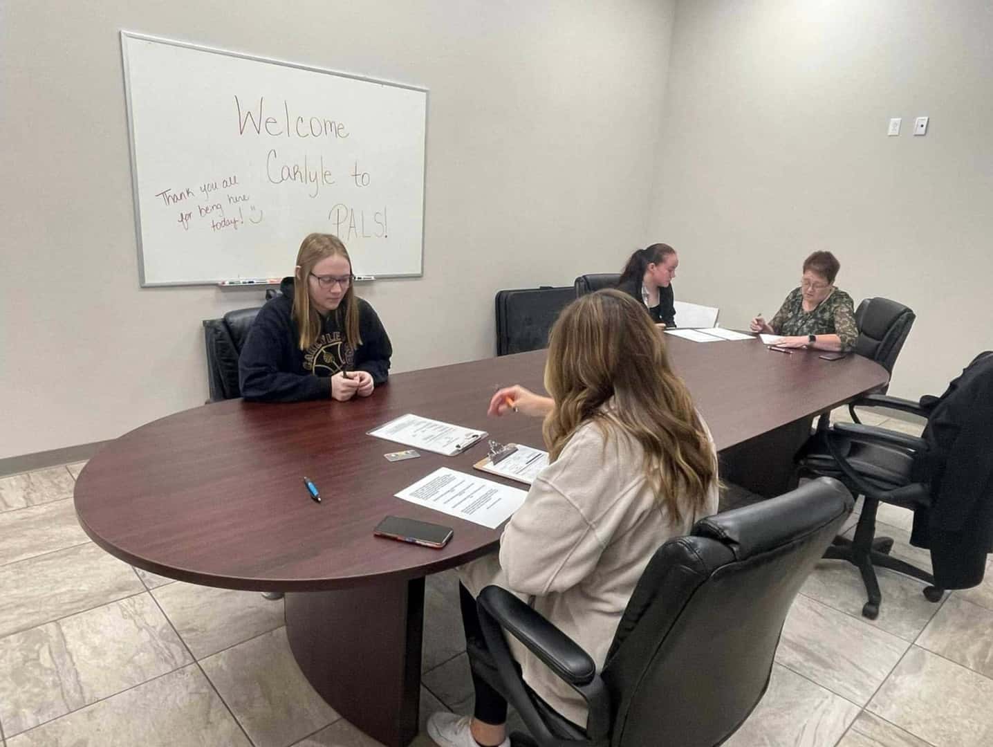 young-people-filling-out-forms-at-a-desk