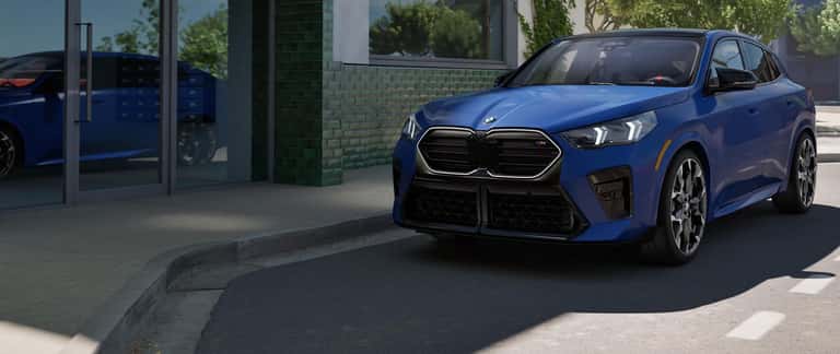 Angled view of a 2024 Zandvoort Blue M2 Coupe driving