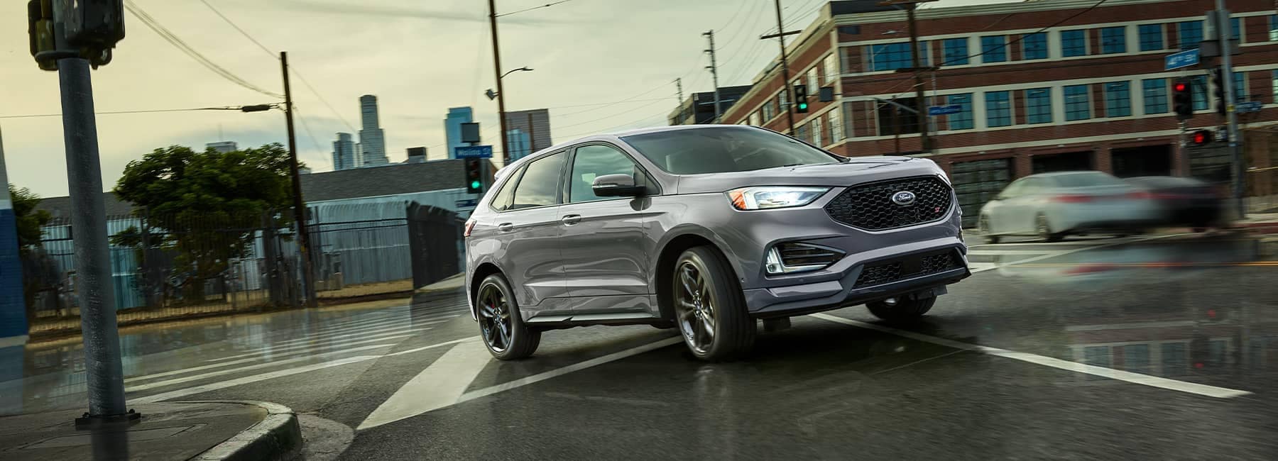 Front passenger view of a Silver 2022 Ford Edge on an urban road