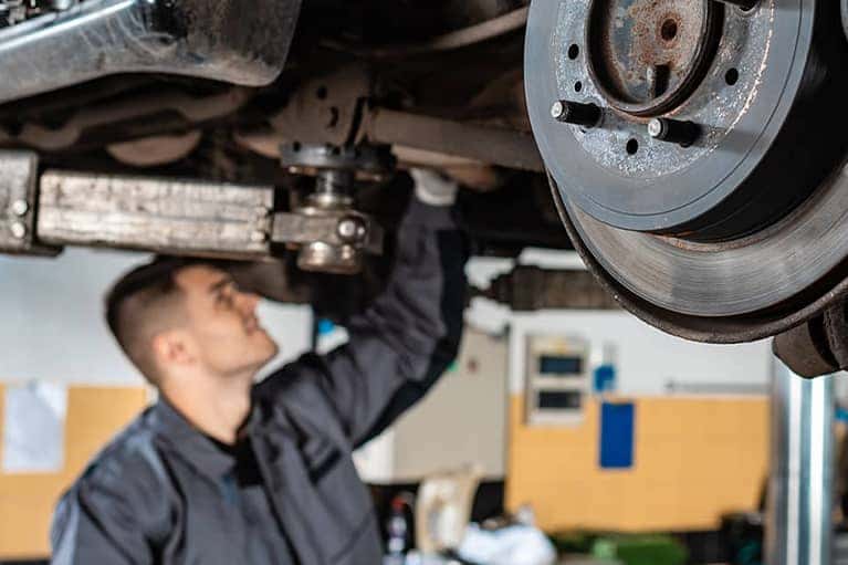 Mechanic-working-on-under-an-elevated-car_mobile