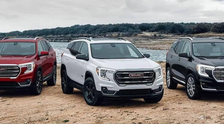 Group of 2023 GMC Terrain SUVs parked on beach_mobile