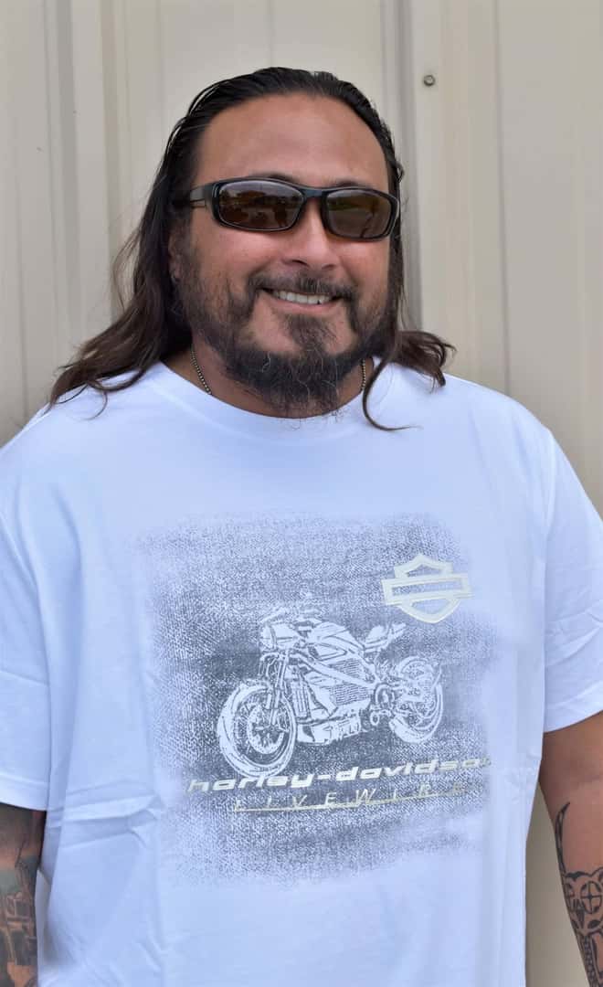 man wearing a white harley davidson shirt
