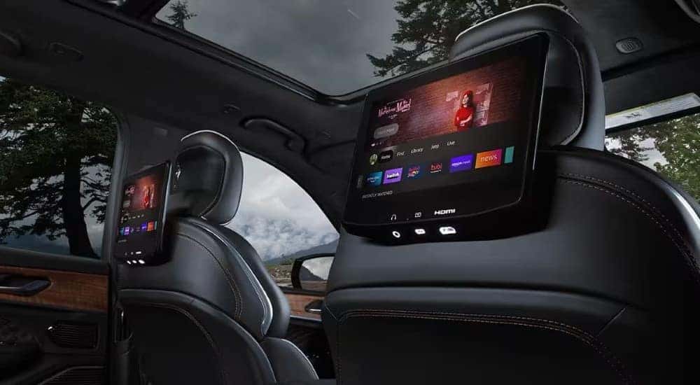 Screens are shown on the headrests in a 2024 Jeep Grand Cherokee.
