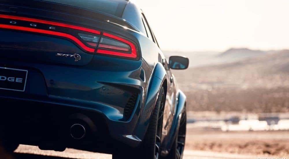 A close-up shows the passenger side taillight on a blue 2020 Dodge Charger SRT Hellcat Widebody.