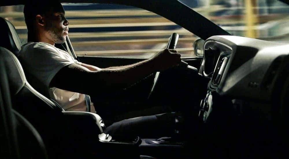 A person is shown driving a 2021 Dodge Charger to a Dodge dealer.