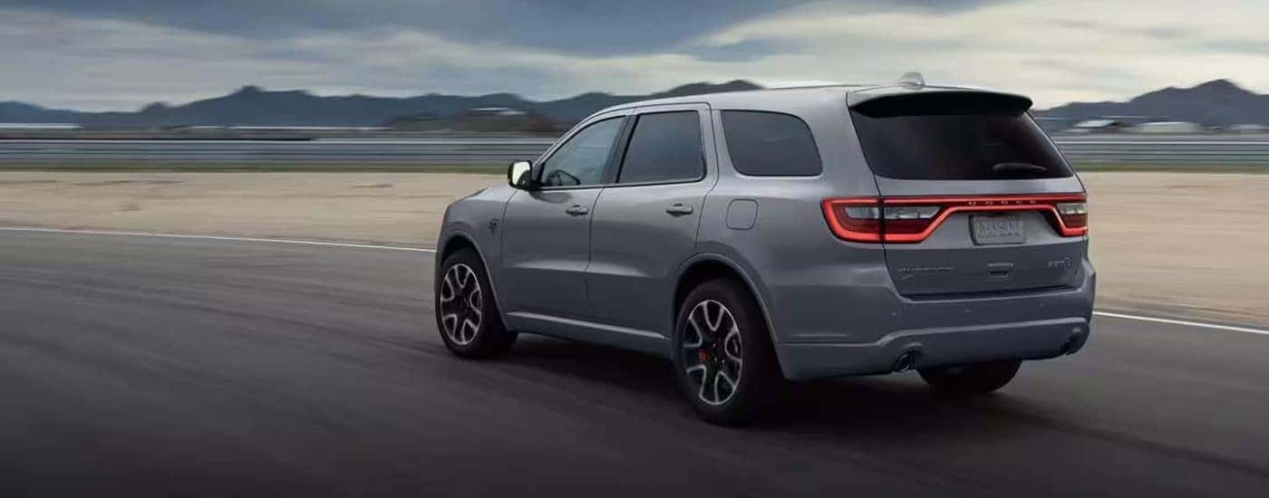 A grey 2022 Dodge Durango SRT is shown from the rear on a racetrack.