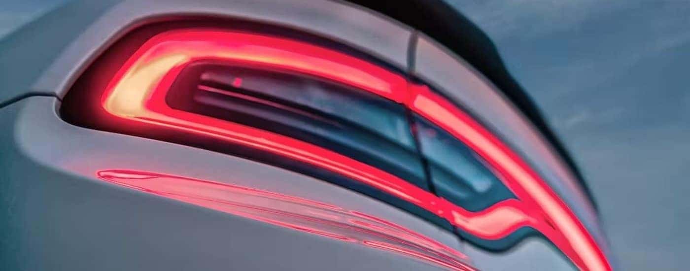 A close up shows the driver side taillight on a white 2023 Dodge Charger.