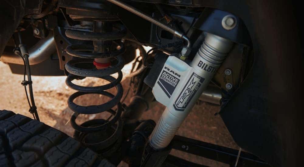 A close-up shows the suspension on a 2024 Ram 1500 TRX.