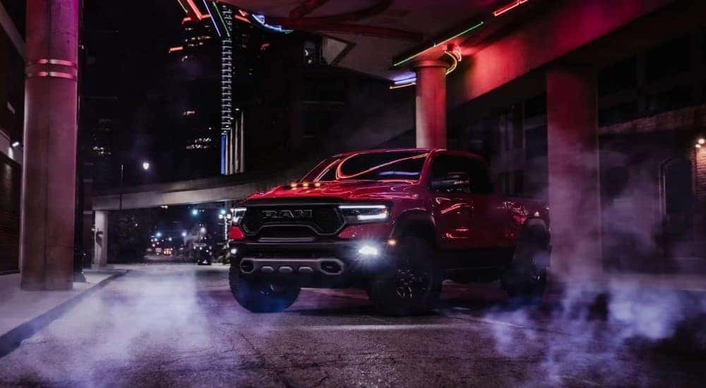 A popular Ram 1500 for sale, a red 2024 Ram 1500 TRX, is shown parked in an alleyway.