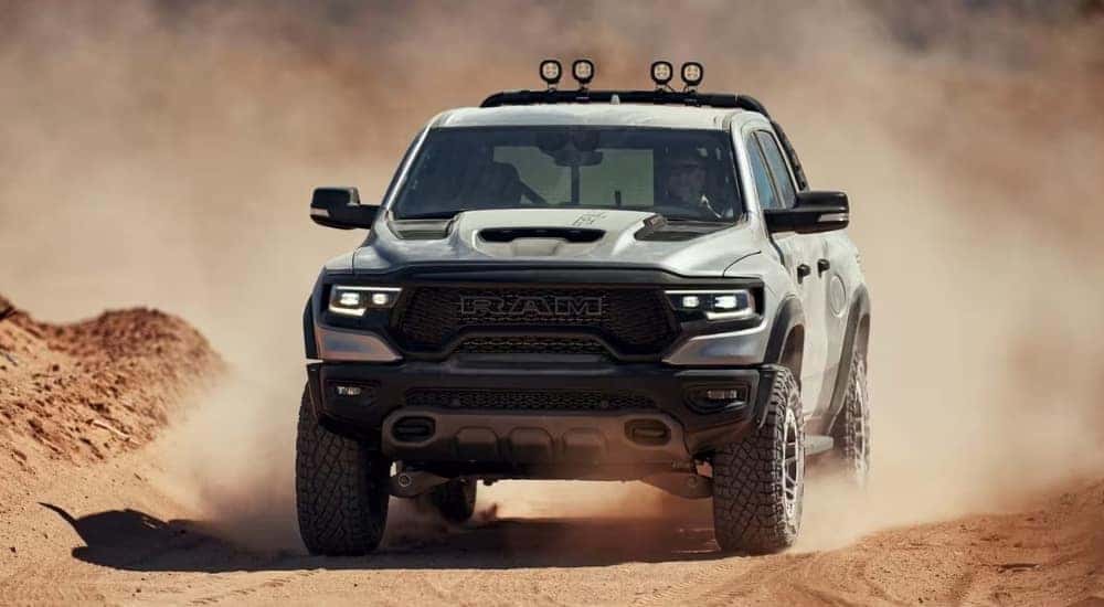 A silver 2024 Ram 1500 TRX is shown off-road.