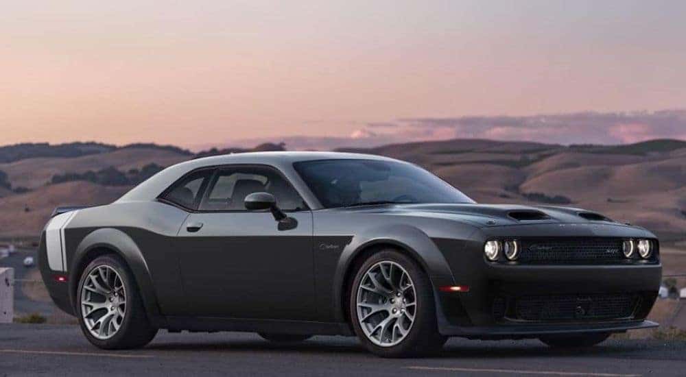 A black 2023 Dodge Challenger SRT Black Ghost is shown from the side.