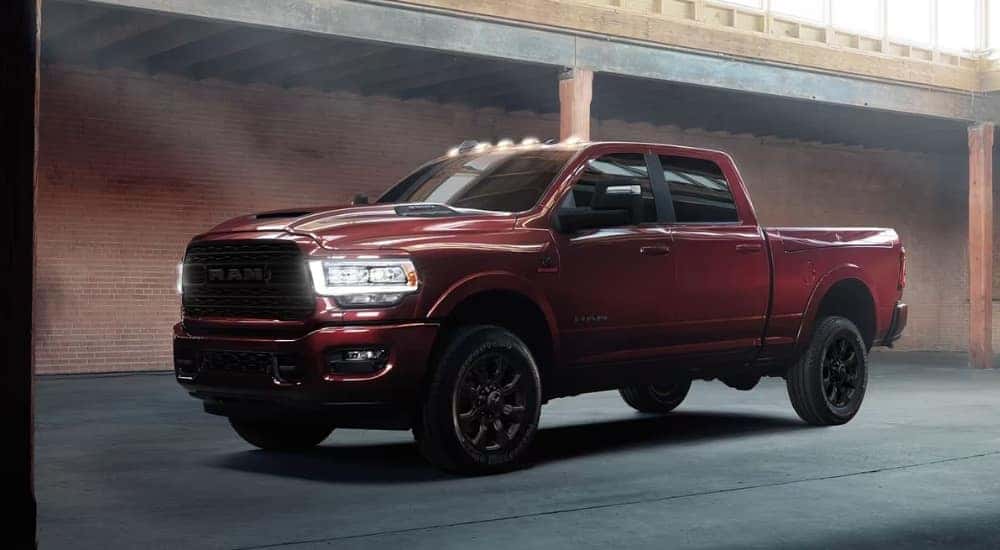A red 2024 Ram 2500 for sale parked at a dealership.