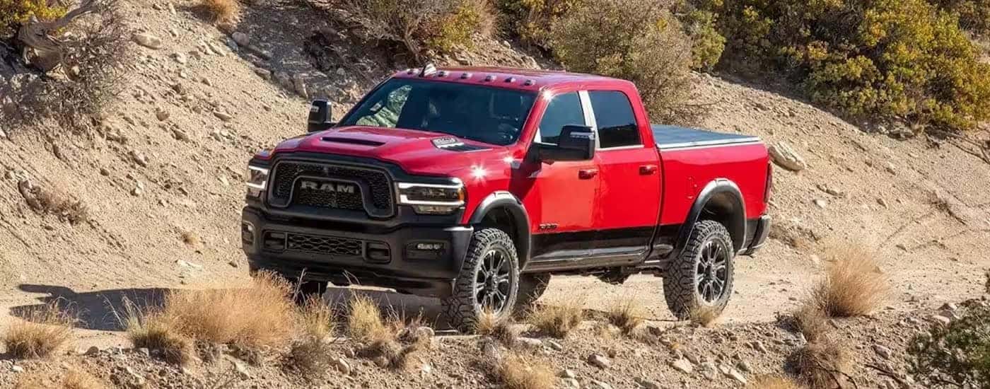 A red 2024 Ram 2500 Rebel is shown from the front at an angle.