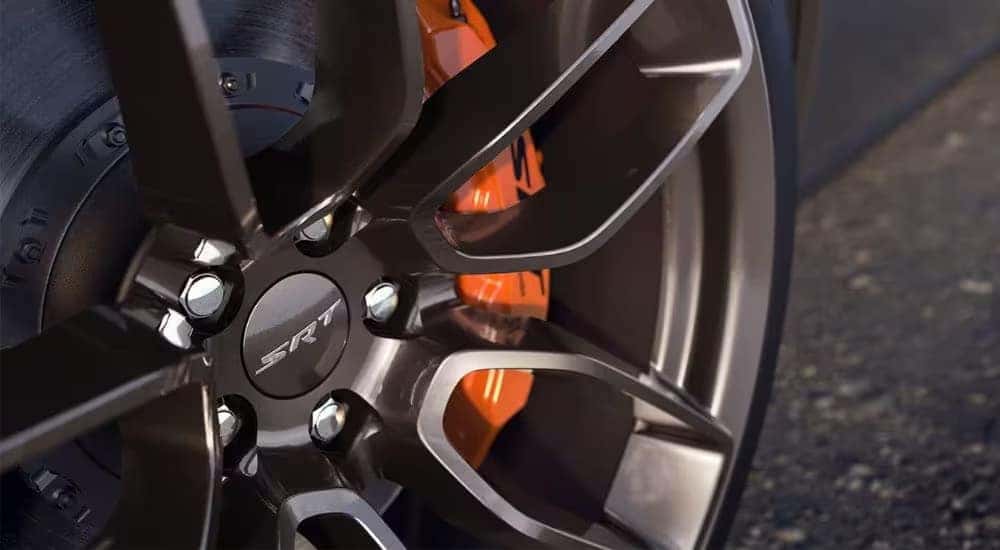 A close-up of a wheel and rim is shown on a 2023 Dodge Charger SRT Hellcat.