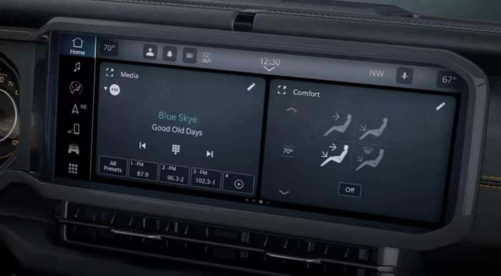 A close-up of the infotainment screen is shown in a 2023 Jeep Wrangler.