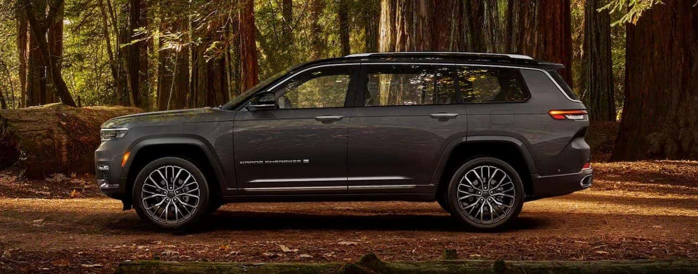A grey 2024 Jeep Grand Cherokee for sale near Charlotte is shown from the side.
