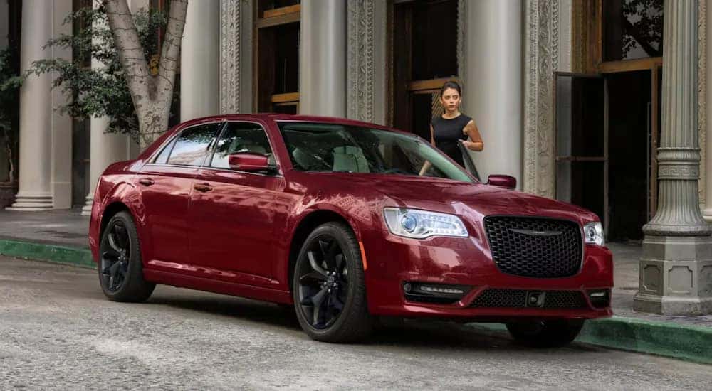 A red 2023 Chrysler 300 Touring L parked on a city street.