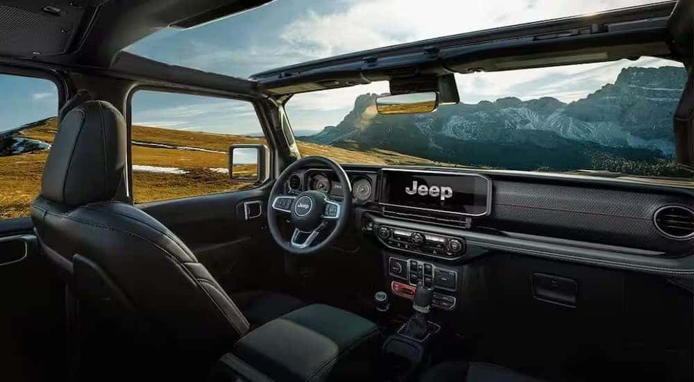 The black interior and dash is shown in a 2024 Jeep Wrangler Rubicon.