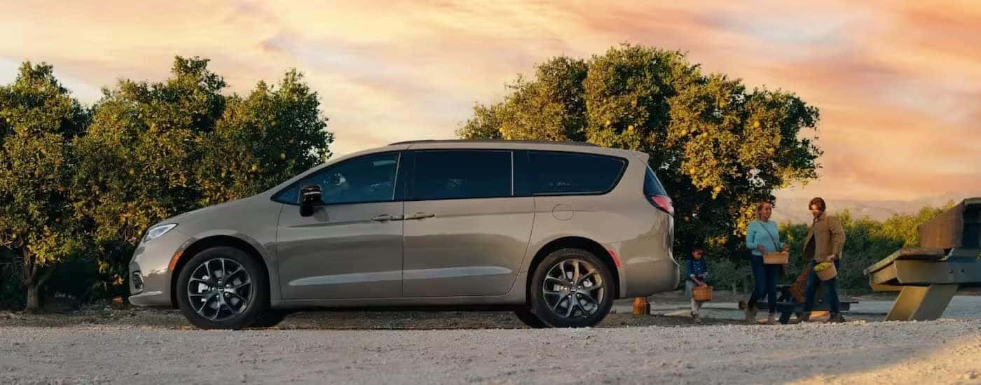 A tan 2023 Chrysler Pacifica is shown from the side.