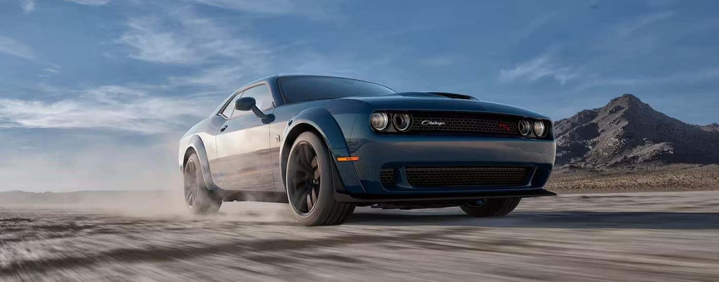 A blue 2023 Dodge Challenger Scat Pack Widebody is shown from the front at an angle.