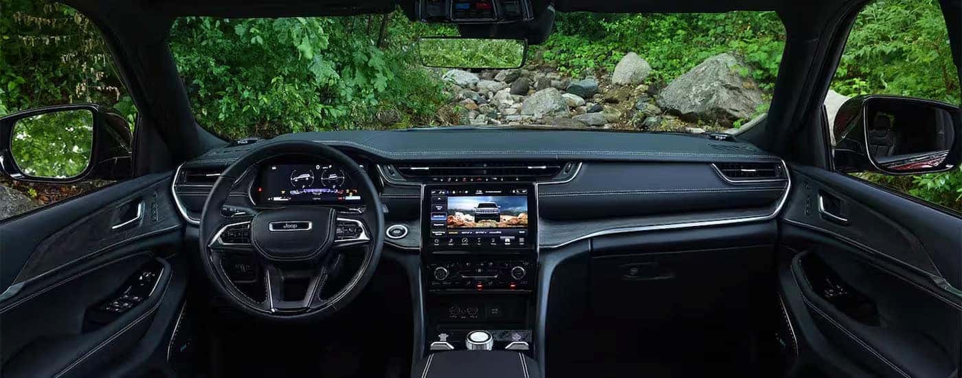 The black interior of a 2024 Jeep Grand Cherokee is shown from above the center console.