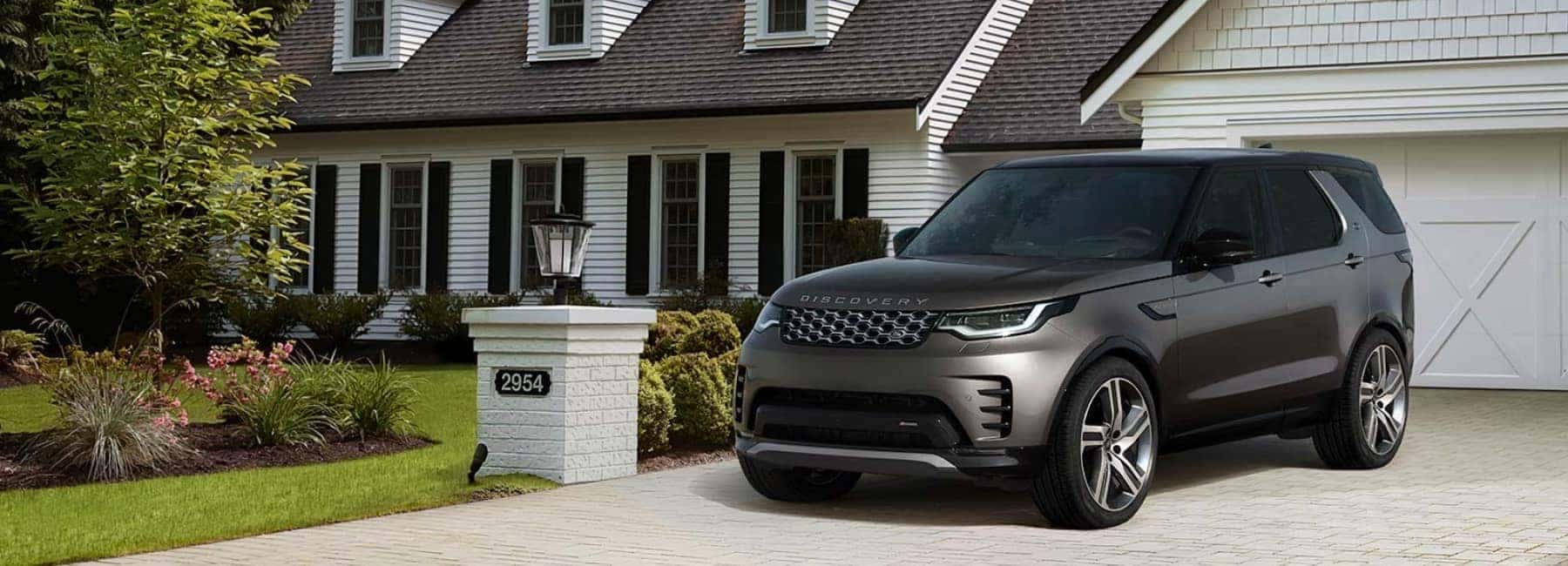2022 Land Rover Discovery parked in the driveway of a large white house