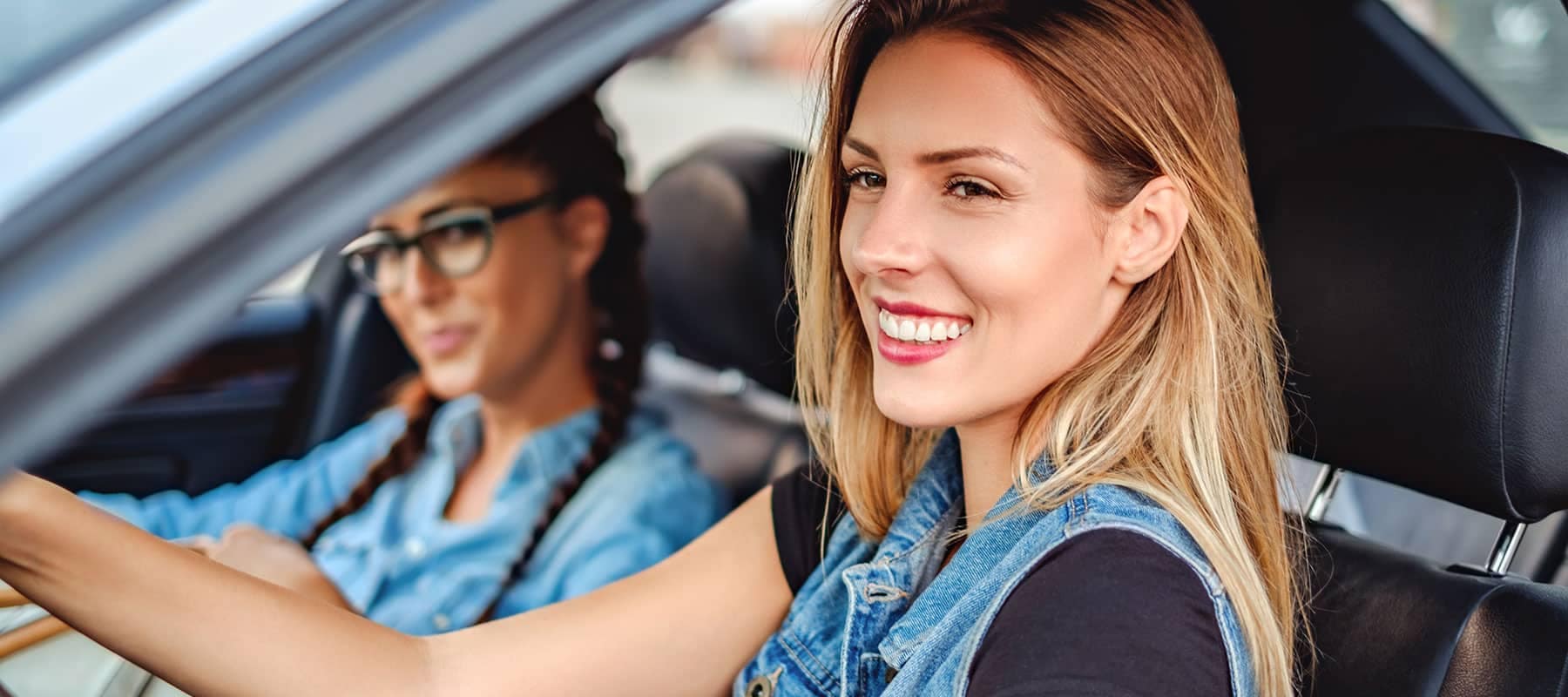 two women in car smiling