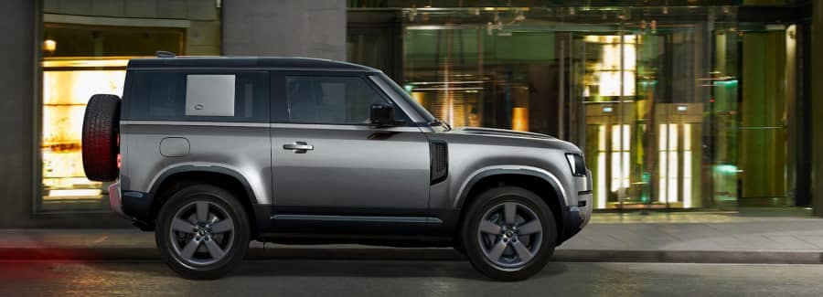 2022landrover_defender-sideview-driving-lg glass doors-grey