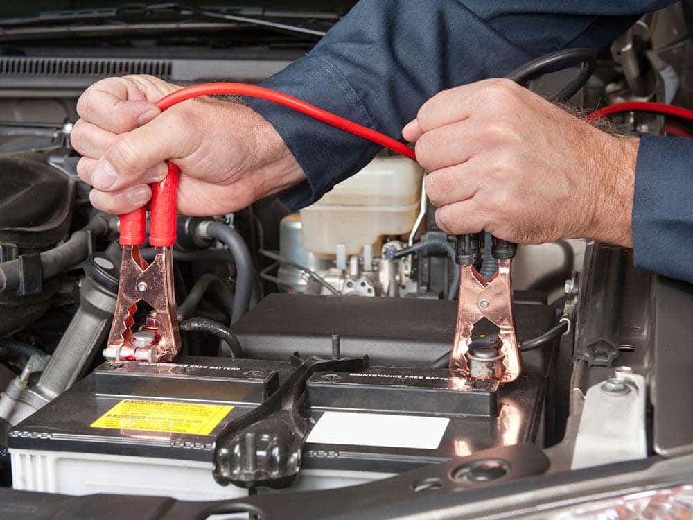 Land Rover technician jumpstarts a battery