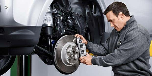Land Rover Mechanic inspects brake calipers