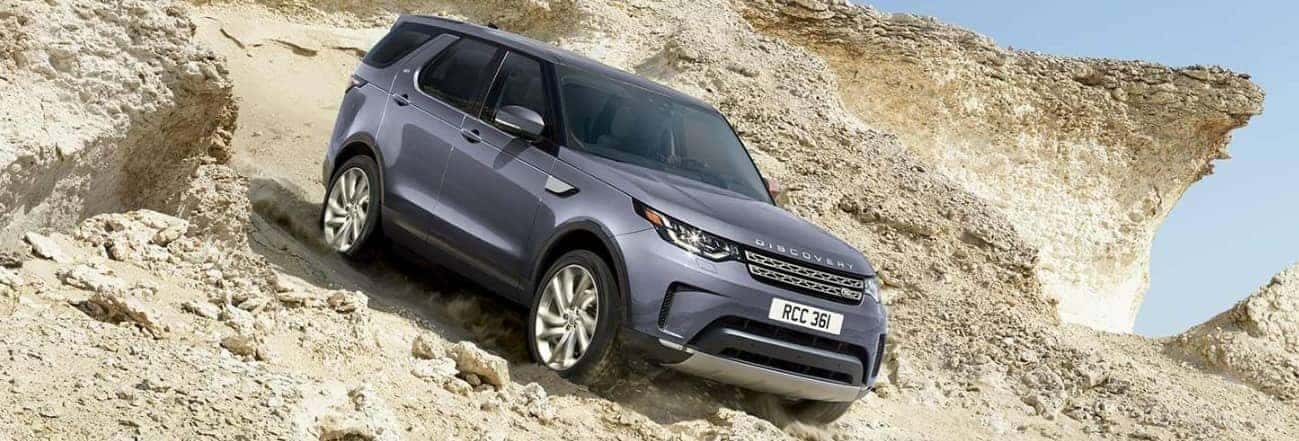Land Rover Discovery driving down a hill